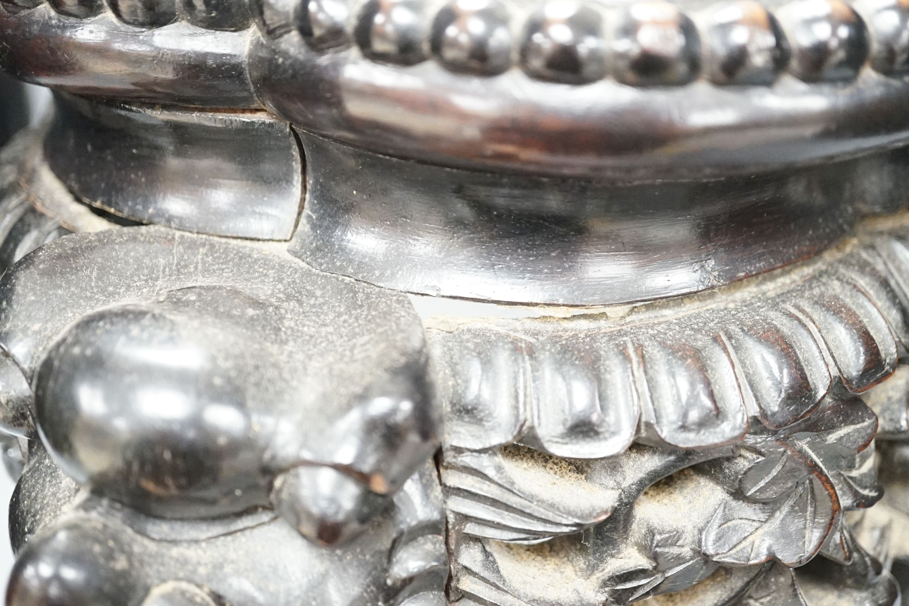 AChinese carved wood jardiniere stand, late Qing dynasty, with hard stone inset, top 26 cms diameter.